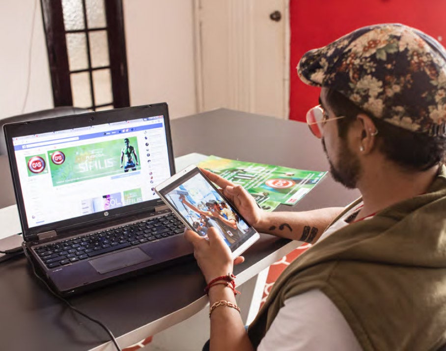 Man holds a tablet that is showing a data monitoring application