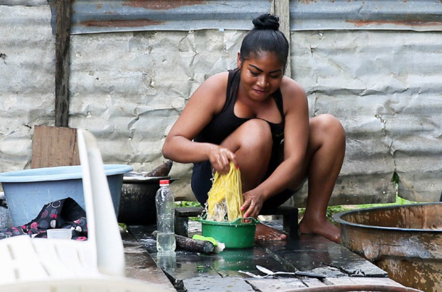 Woman washing clothes by hand