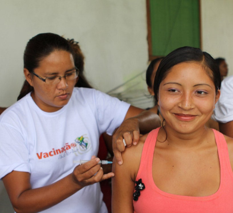 Young woman receiving a vaccine in Brazil