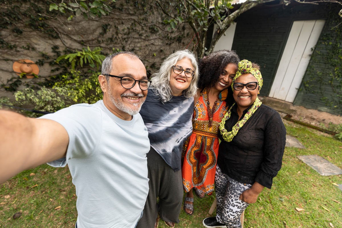 a men and three womans gathering 